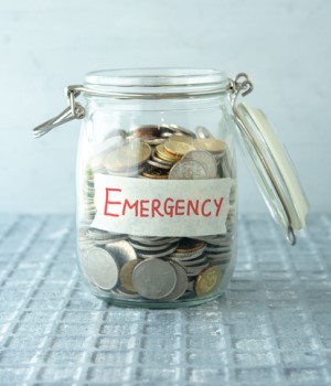 Picture of jar of change with a label on it that says emergency. 