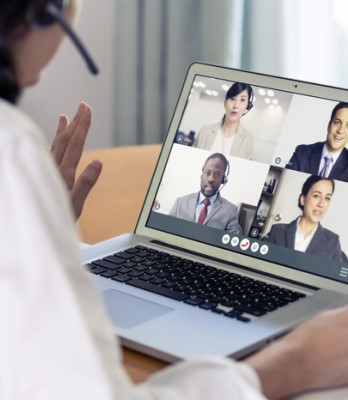 A woman talks on a video call meeting.