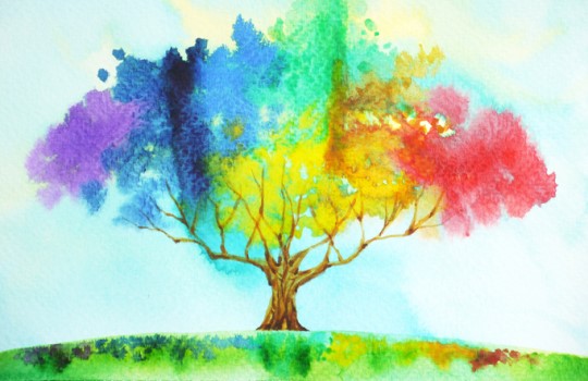 A tree painted in rainbow watercolors.